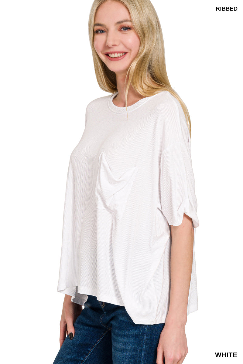 Woman wearing a white ribbed blouse with a plain background