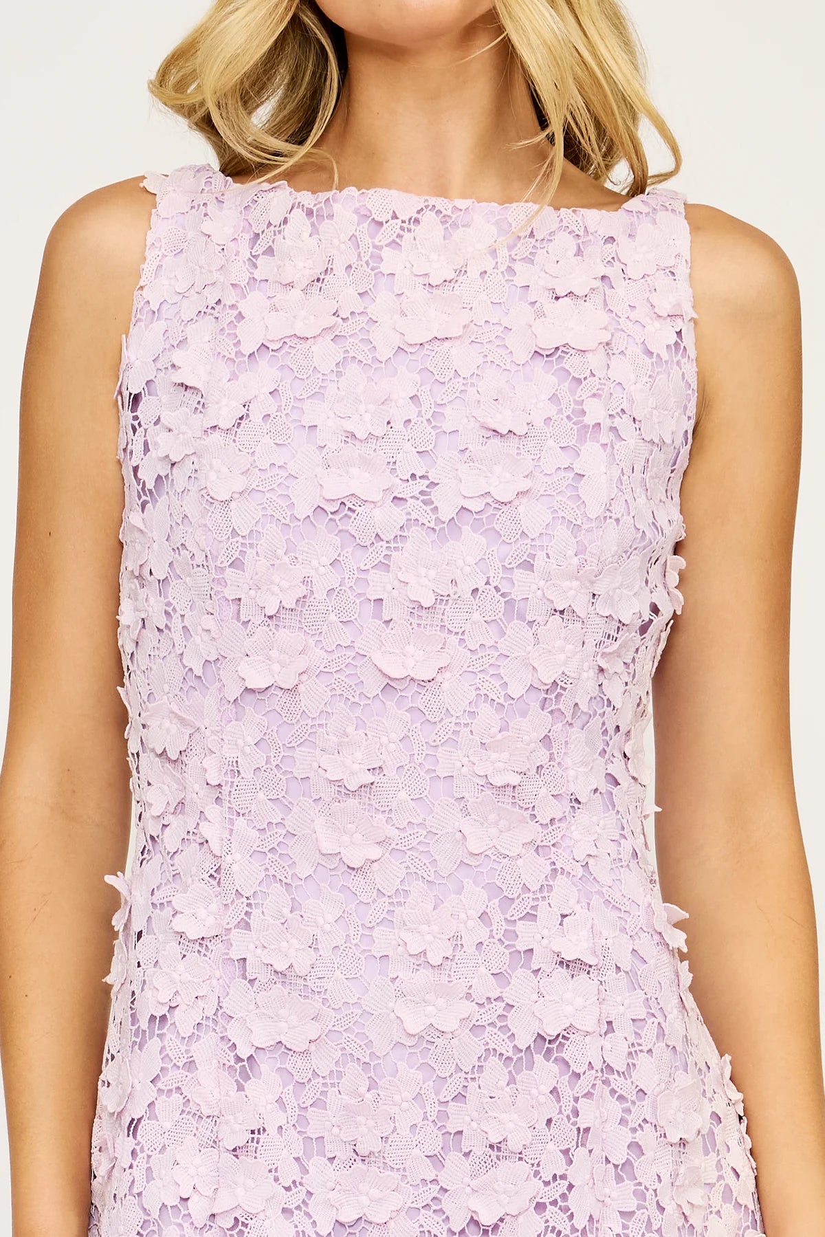 Close-up of a person wearing a light purple floral lace dress.