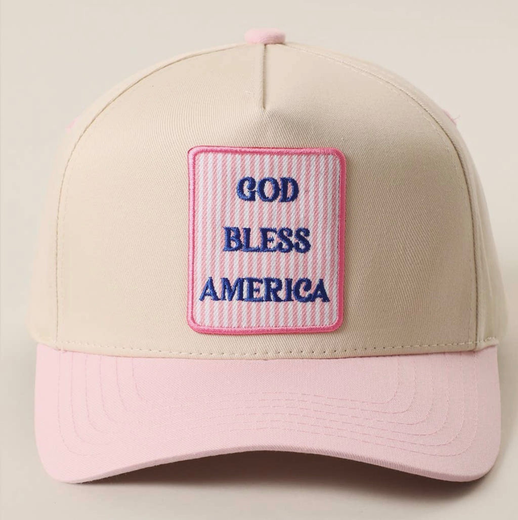 Cap with 'God Bless America' patch on a beige and pink background