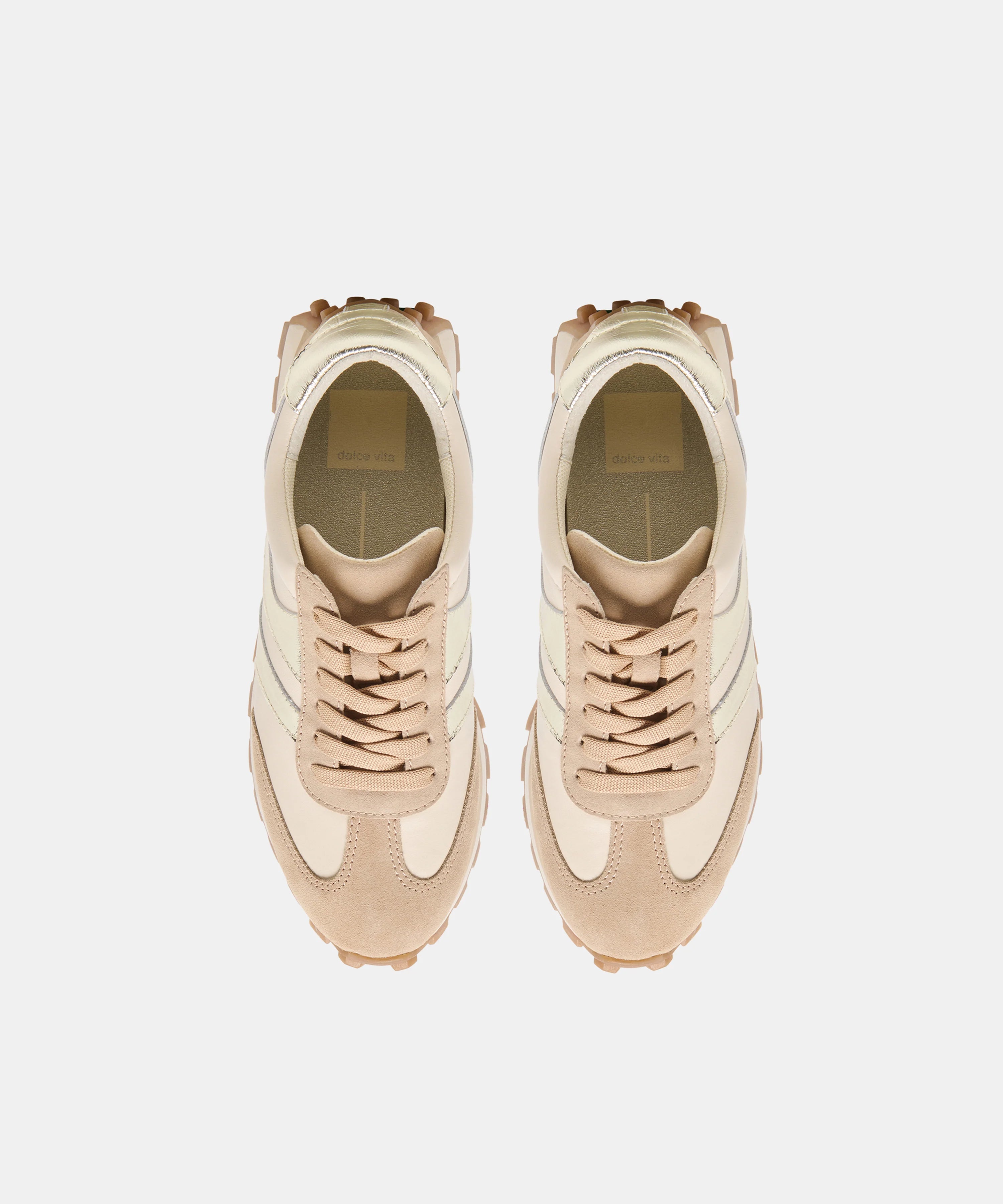 A pair of beige and cream low-top sneakers shown from a top-down view on a light gray background.