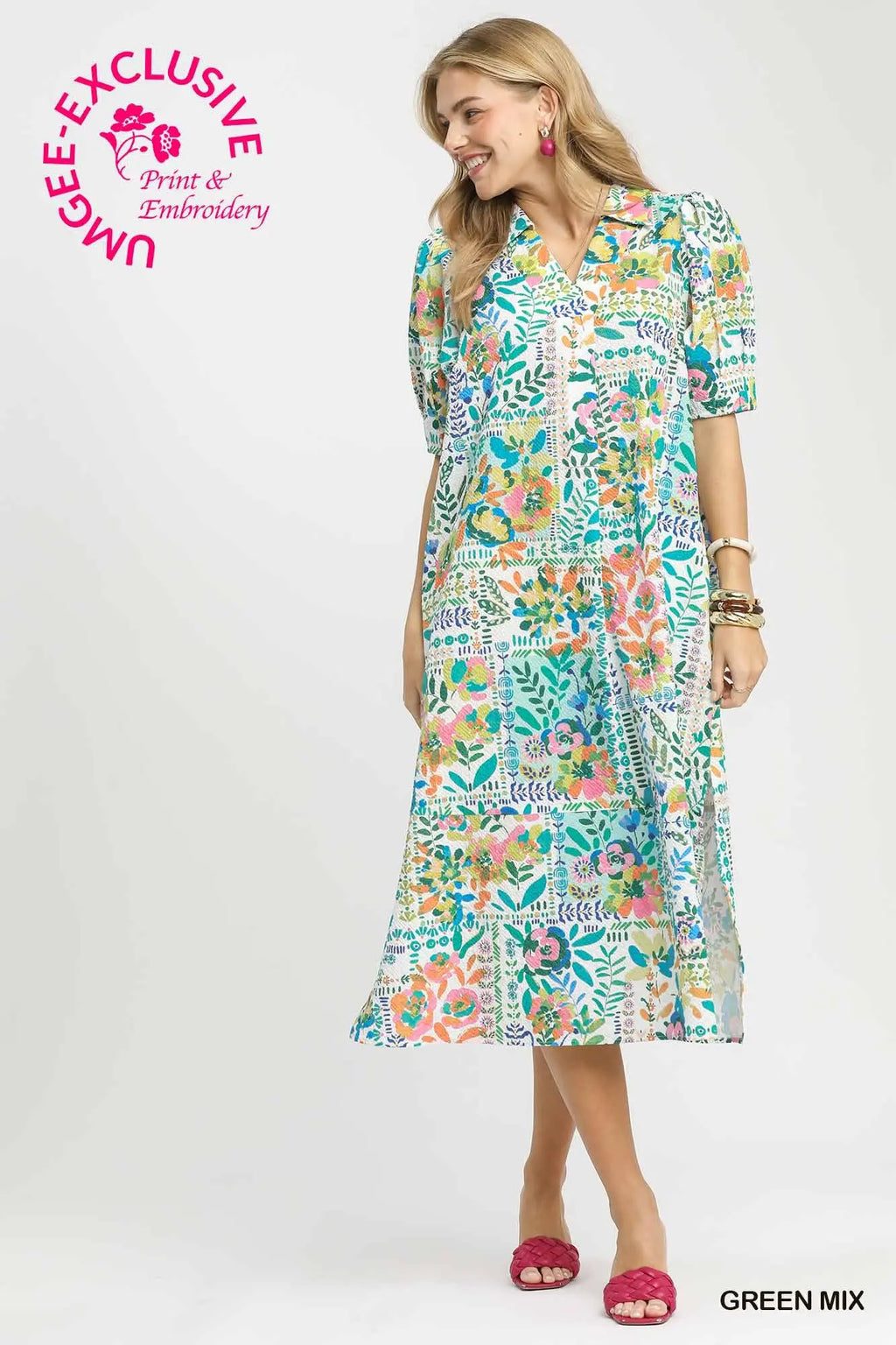 Woman wearing a colorful floral dress on a white background with Umgee branding.
