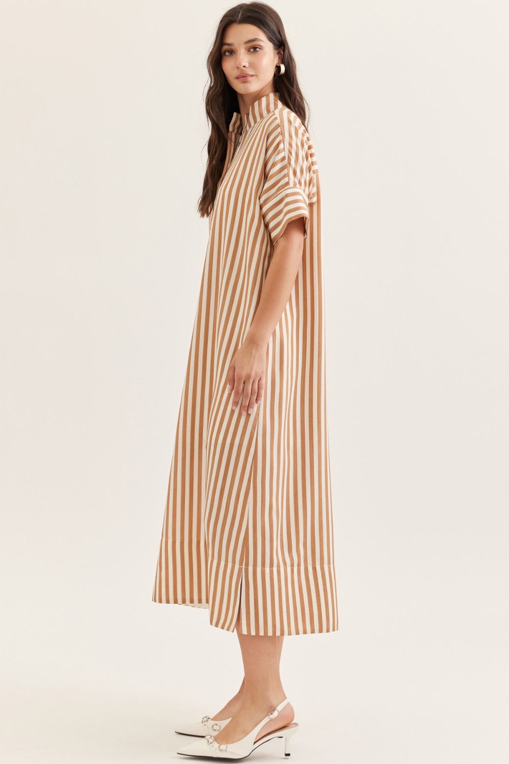 Woman wearing a striped dress on a white background