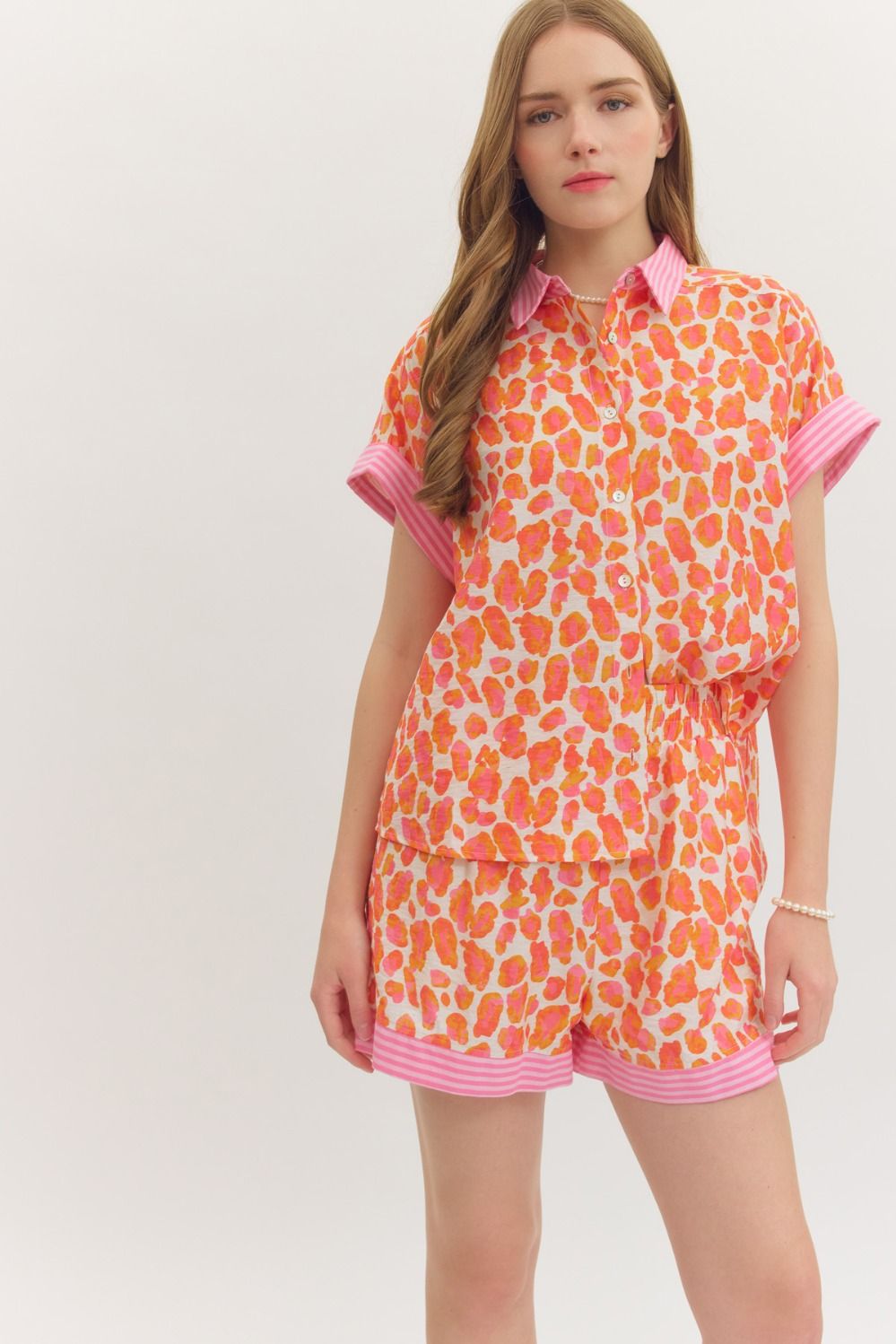 Woman wearing a colorful patterned outfit on a white background