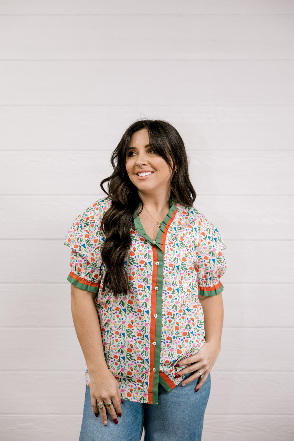 Woman wearing a floral blouse with a white background