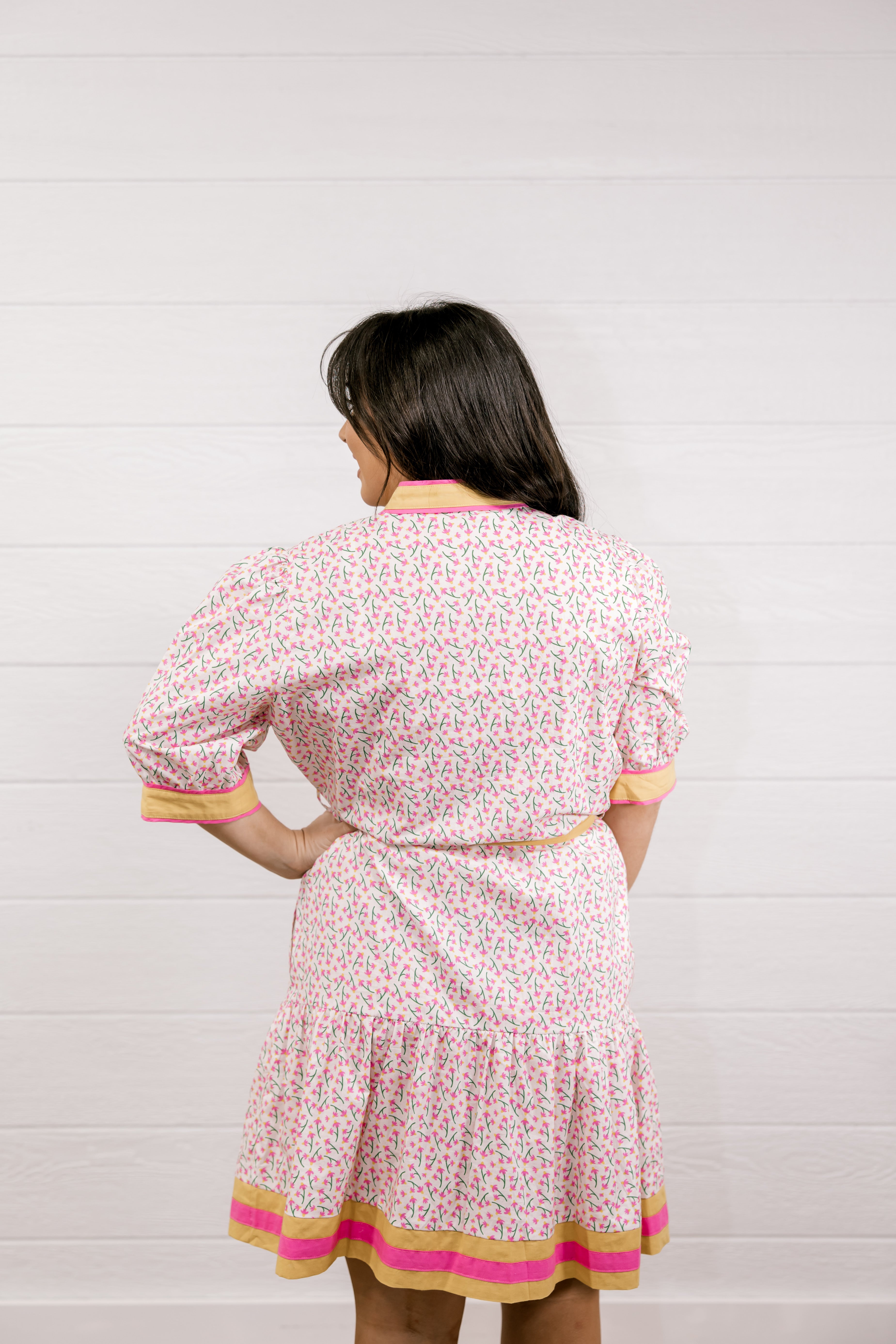 Woman wearing a floral dress with a white background