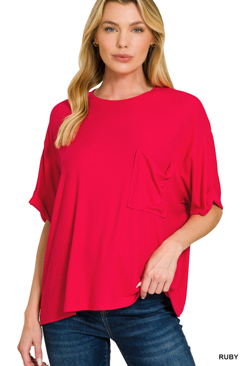 Woman wearing a red oversized t-shirt with a pocket on a white background