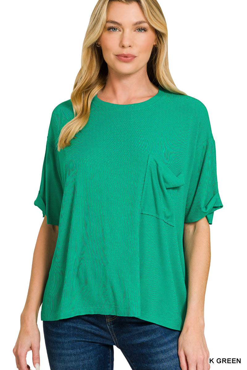 Woman wearing a green oversized t-shirt with a pocket on a white background