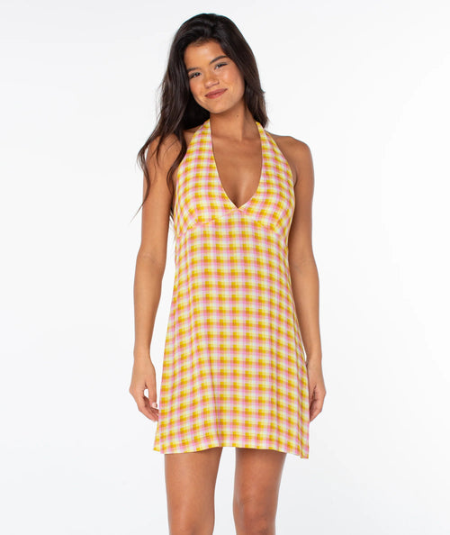 Woman wearing a yellow checkered dress on a white background