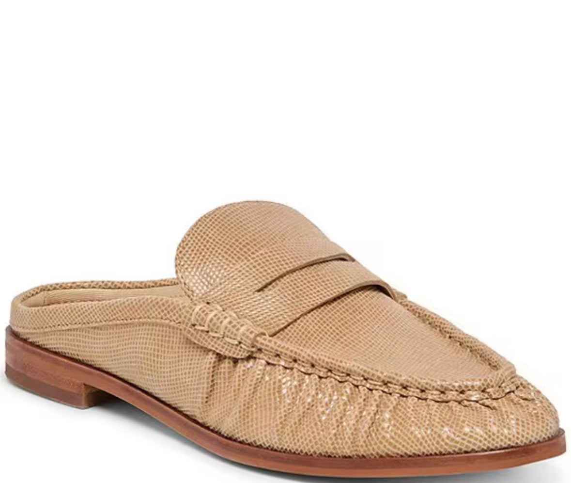 A single tan textured slip-on loafer mule with a braided detail across the vamp and a low brown heel, shown on a plain white background.