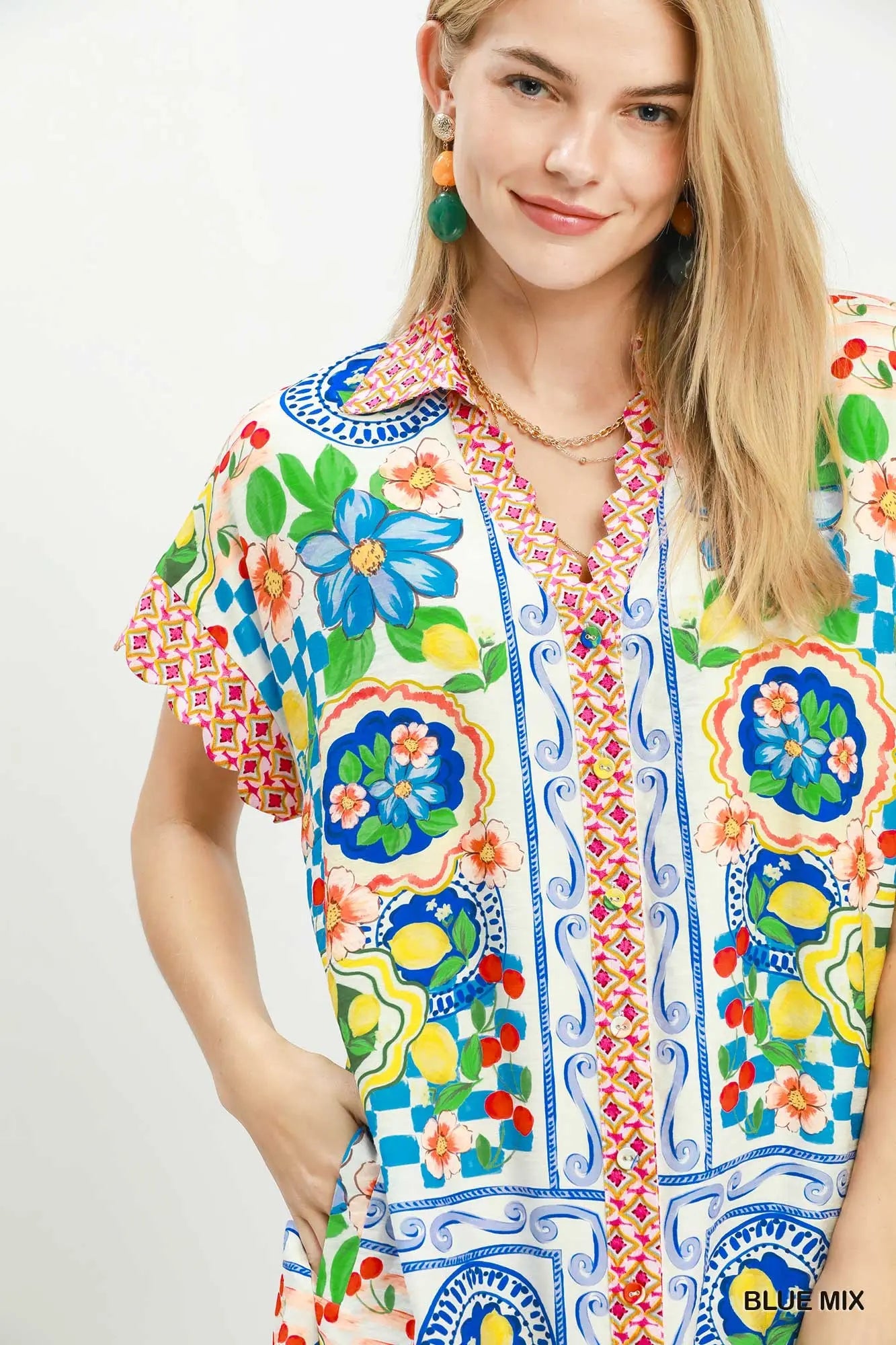 Woman wearing a colorful patterned shirt with a white background