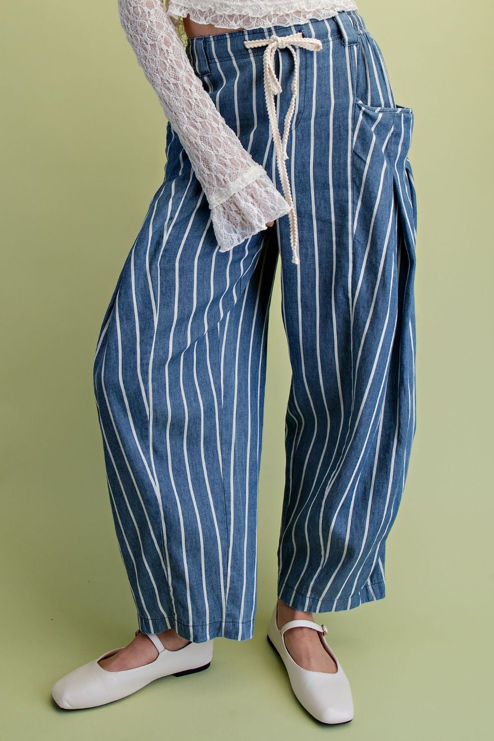 Blue and white striped pants worn by a person on a green background