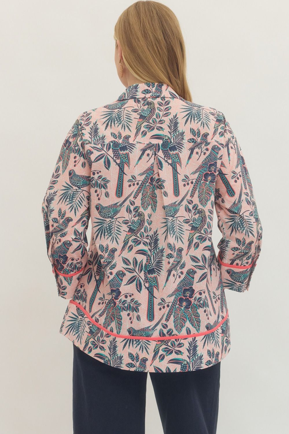 Woman wearing a patterned jacket with a white background