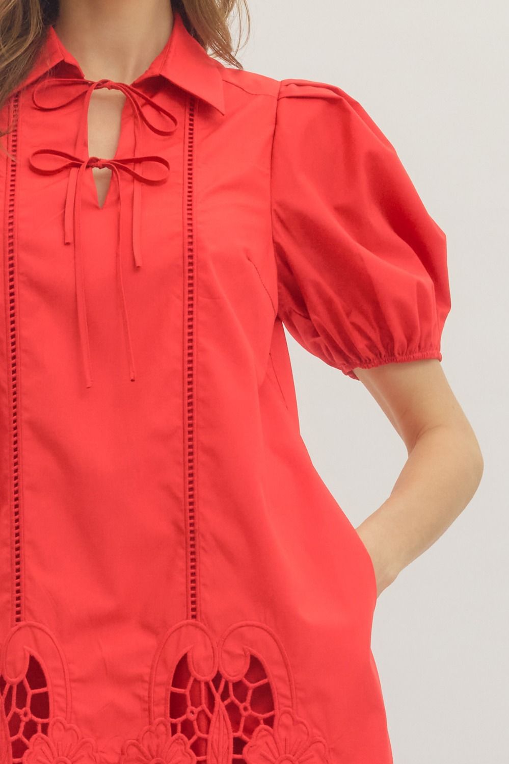 Red dress with puff sleeves on a plain background