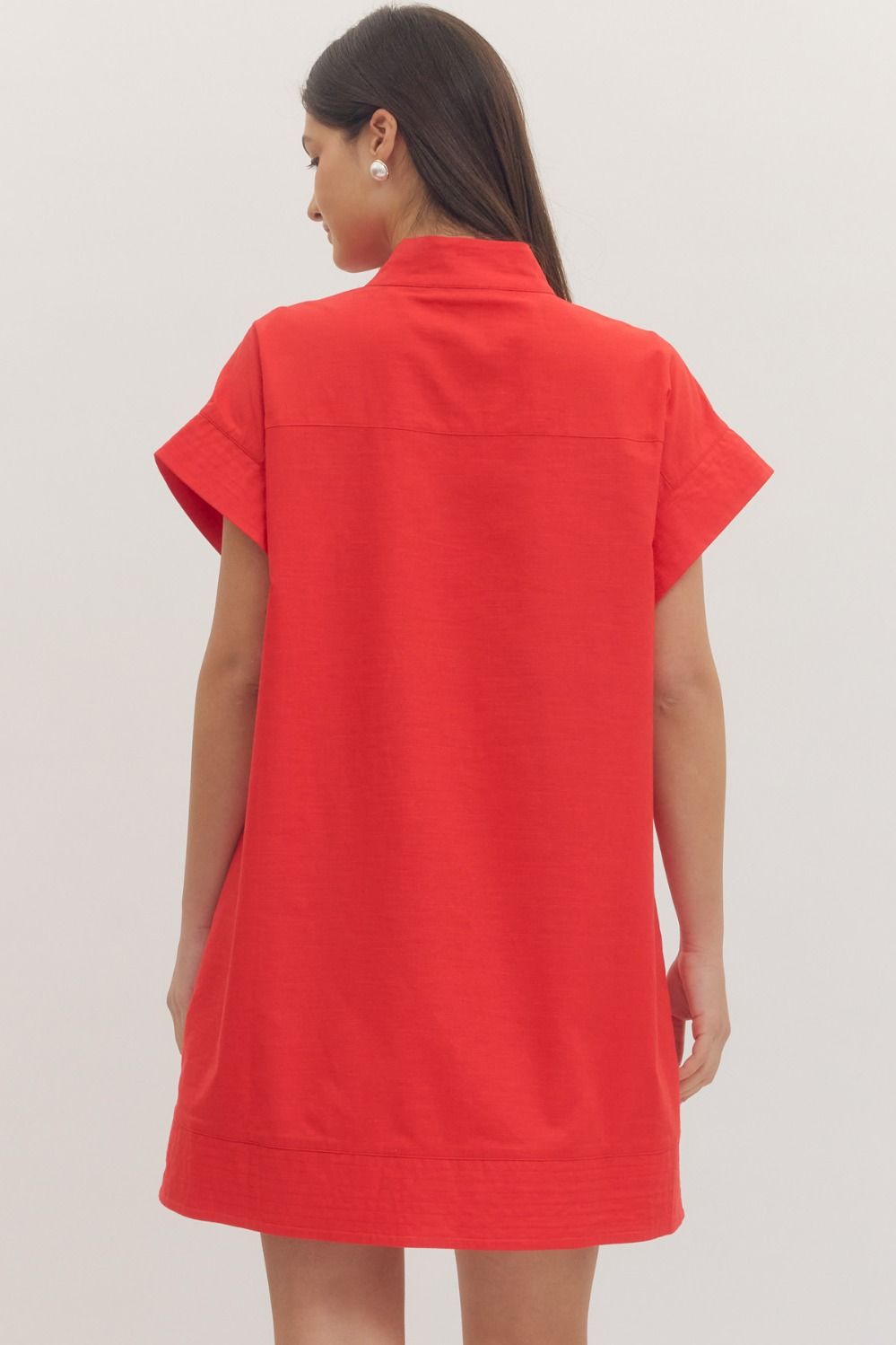 Red dress worn by a person on a light gray background
