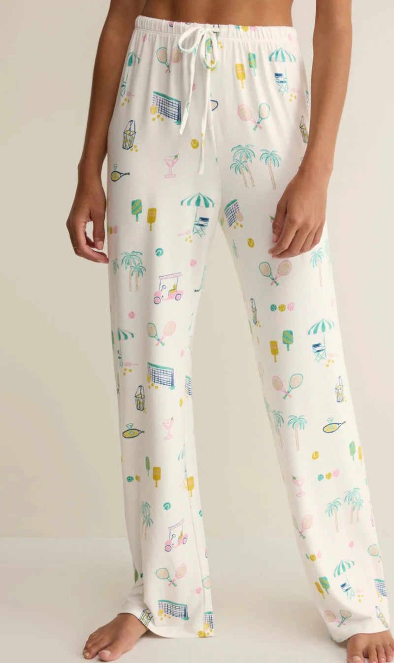 White pajama pants with colorful patterns on a plain background