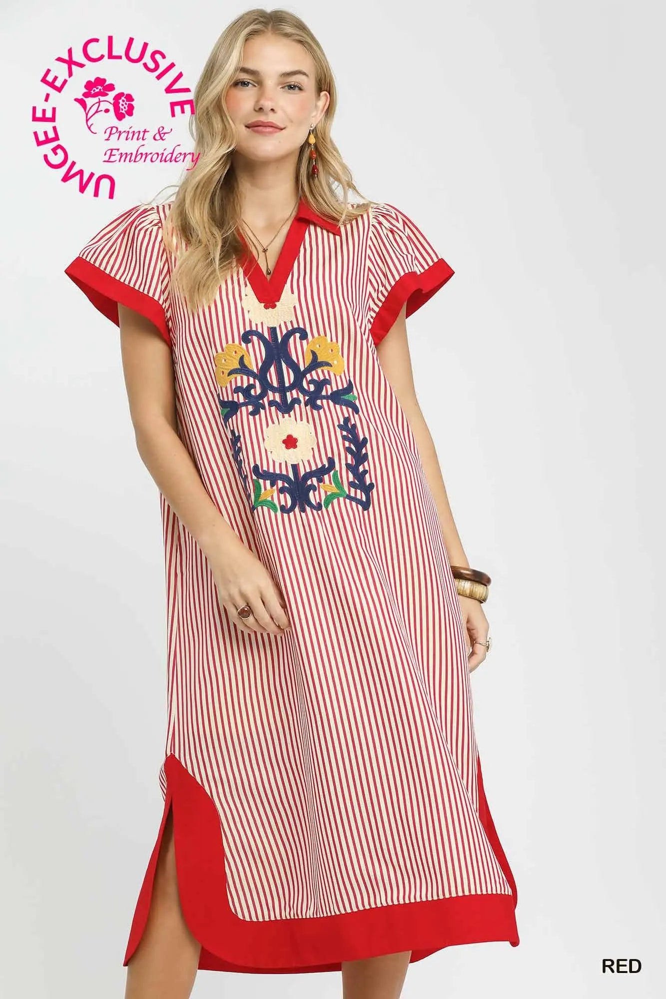 Woman wearing a red and white striped dress with embroidery on a white background