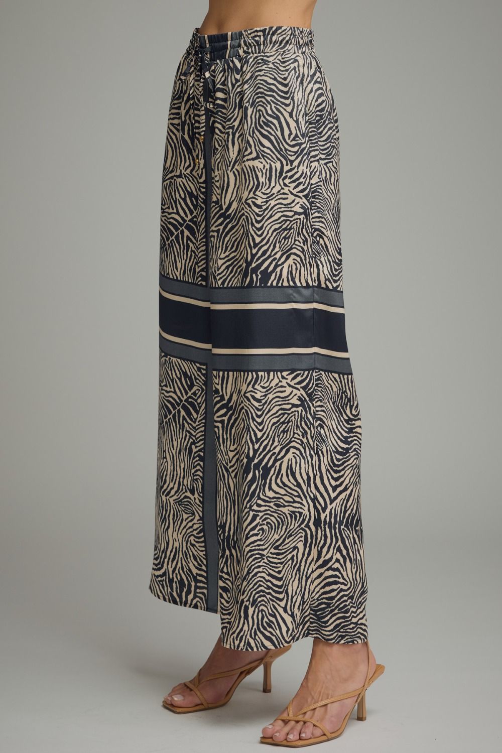 Zebra print skirt with black accents on a gray background