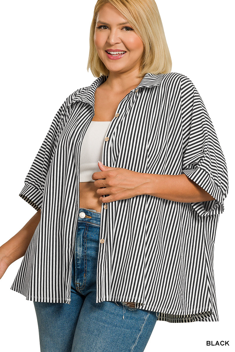 Woman wearing a black and white striped shirt with rolled-up sleeves on a white background