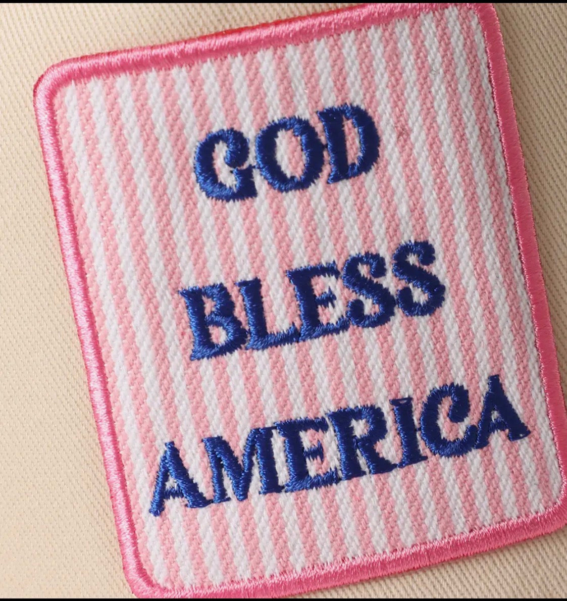 Embroidered patch with 'GOD BLESS AMERICA' text on a striped background