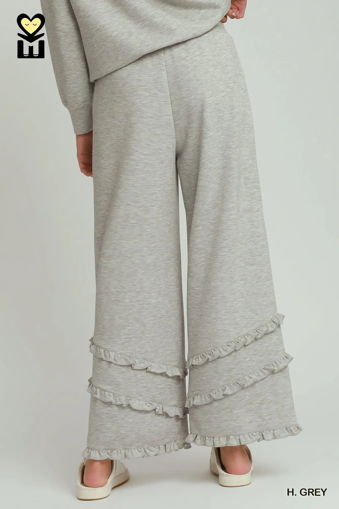 Gray ruffled pants on a plain background