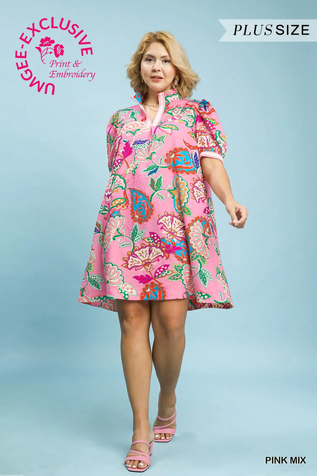 Woman wearing a pink floral dress on a light blue background with branding text.