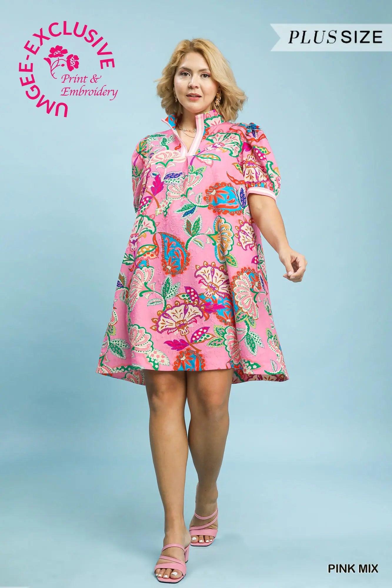 Woman wearing a pink floral dress on a light blue background with branding text.