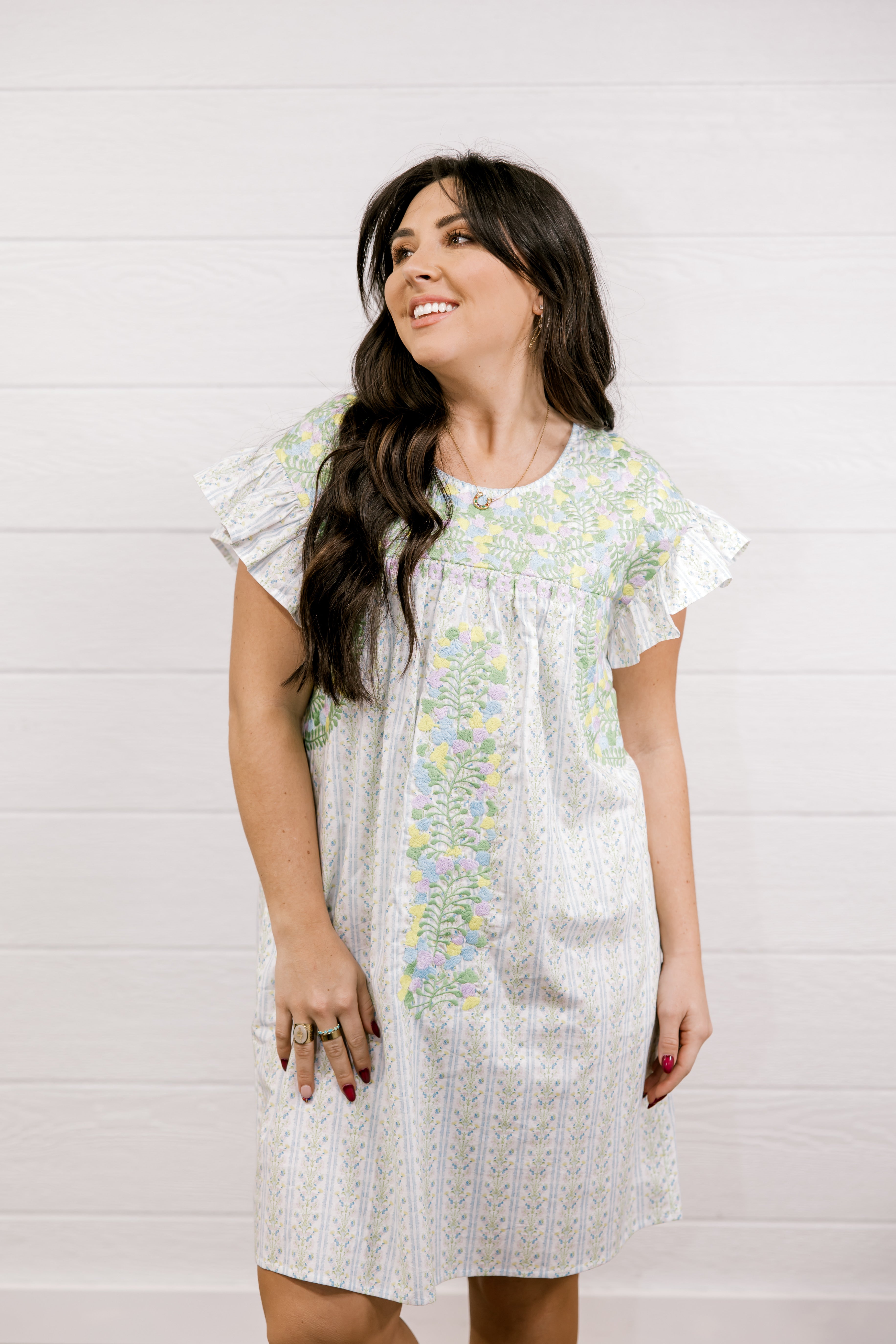 Woman wearing a floral dress against a white background