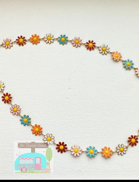 Colorful flower garland with a small camper illustration on a white background