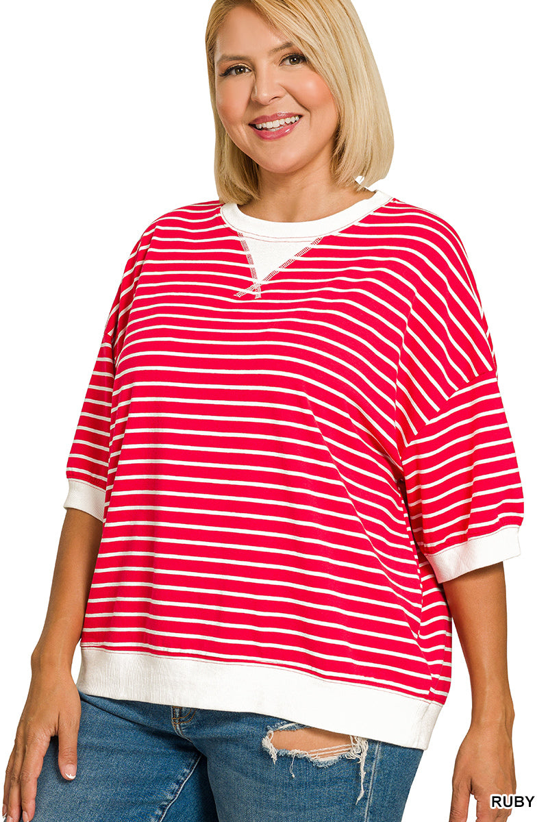 Woman wearing a red and white striped shirt with a white collar on a white background
