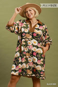 Woman wearing a floral dress with a brown hat against a green background