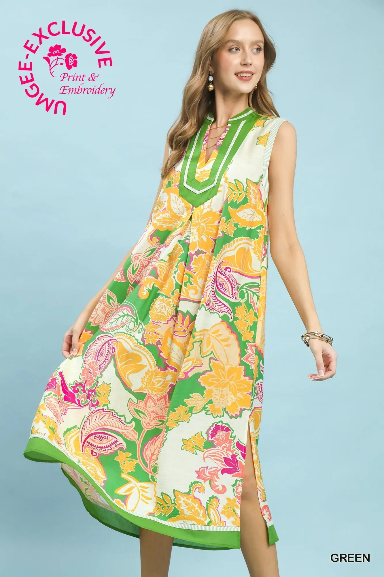 Woman wearing a colorful floral dress with 'UMEE Exclusive' branding on a light blue background.