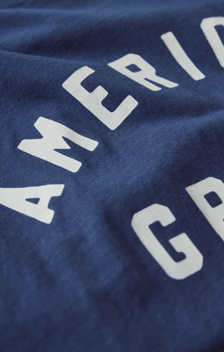 Close-up of a blue fabric with 'American' printed in white letters.