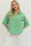 Woman wearing a green checkered shirt against a white background