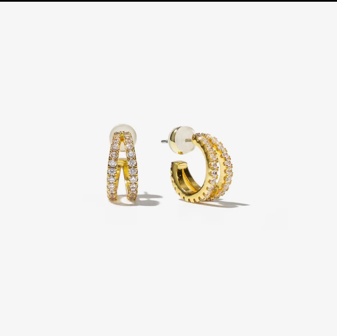 Gold hoop earrings with embedded stones on a white background