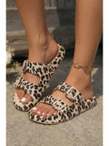 Leopard print sandals worn on feet with a blurred background