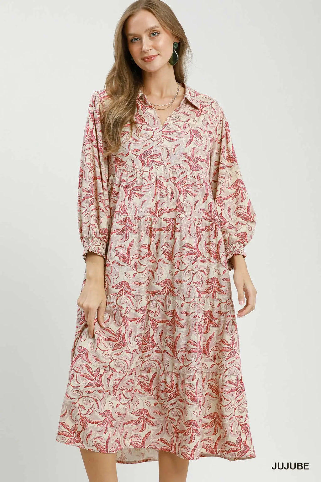 Woman wearing a patterned dress on a white background