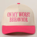 Beige and pink cap with 'On My Worst Behavior' text on a beige background