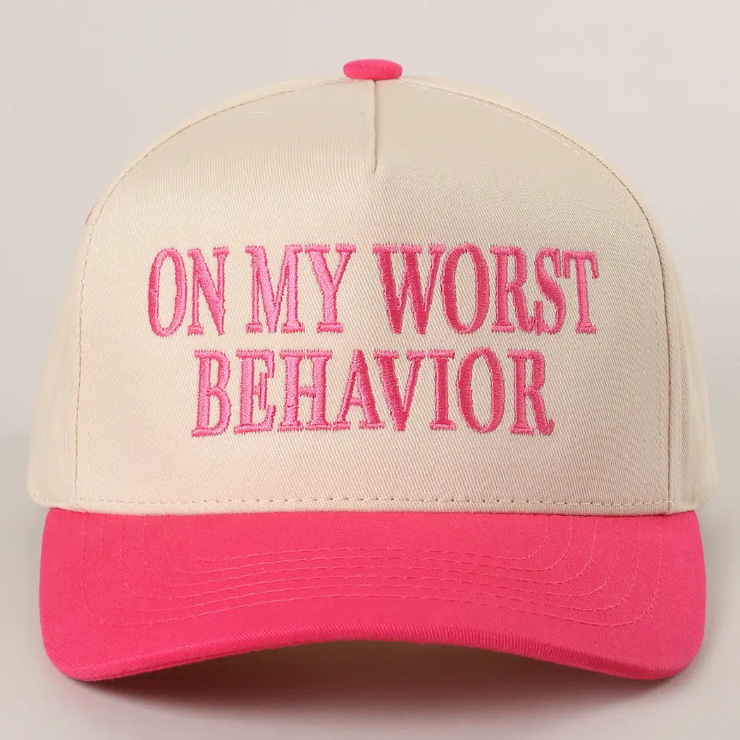 Beige and pink cap with 'On My Worst Behavior' text on a beige background