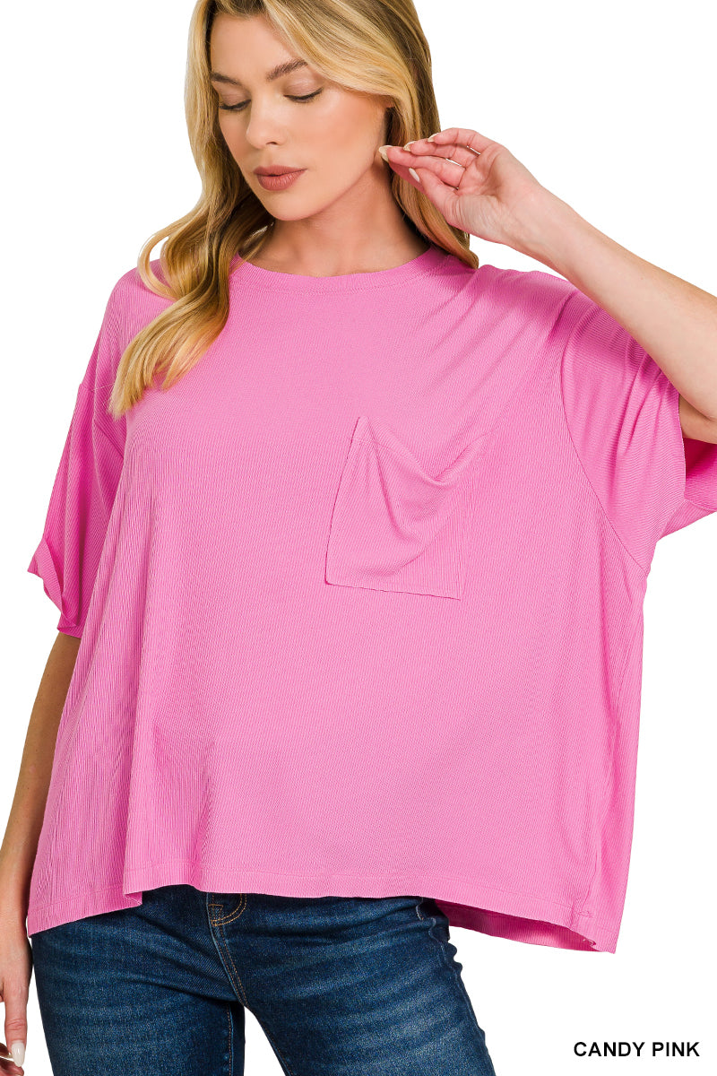 Woman wearing a pink oversized top with a pocket on a white background