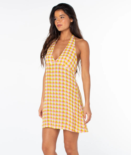 Woman wearing a yellow checkered dress on a white background