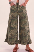 Camouflage wide-leg pants with ruffles worn by a person on a plain background