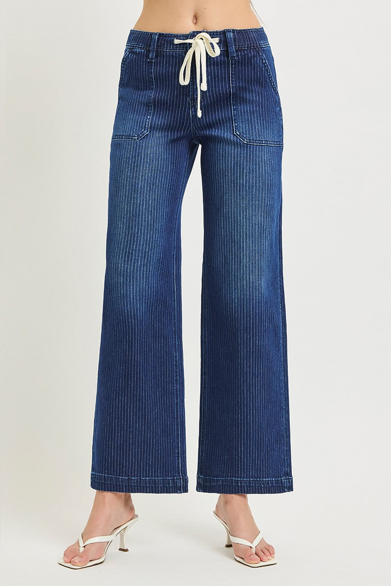 Blue denim pants with a drawstring waist on a white background