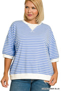 Woman wearing a blue and white striped sweater with a plain background