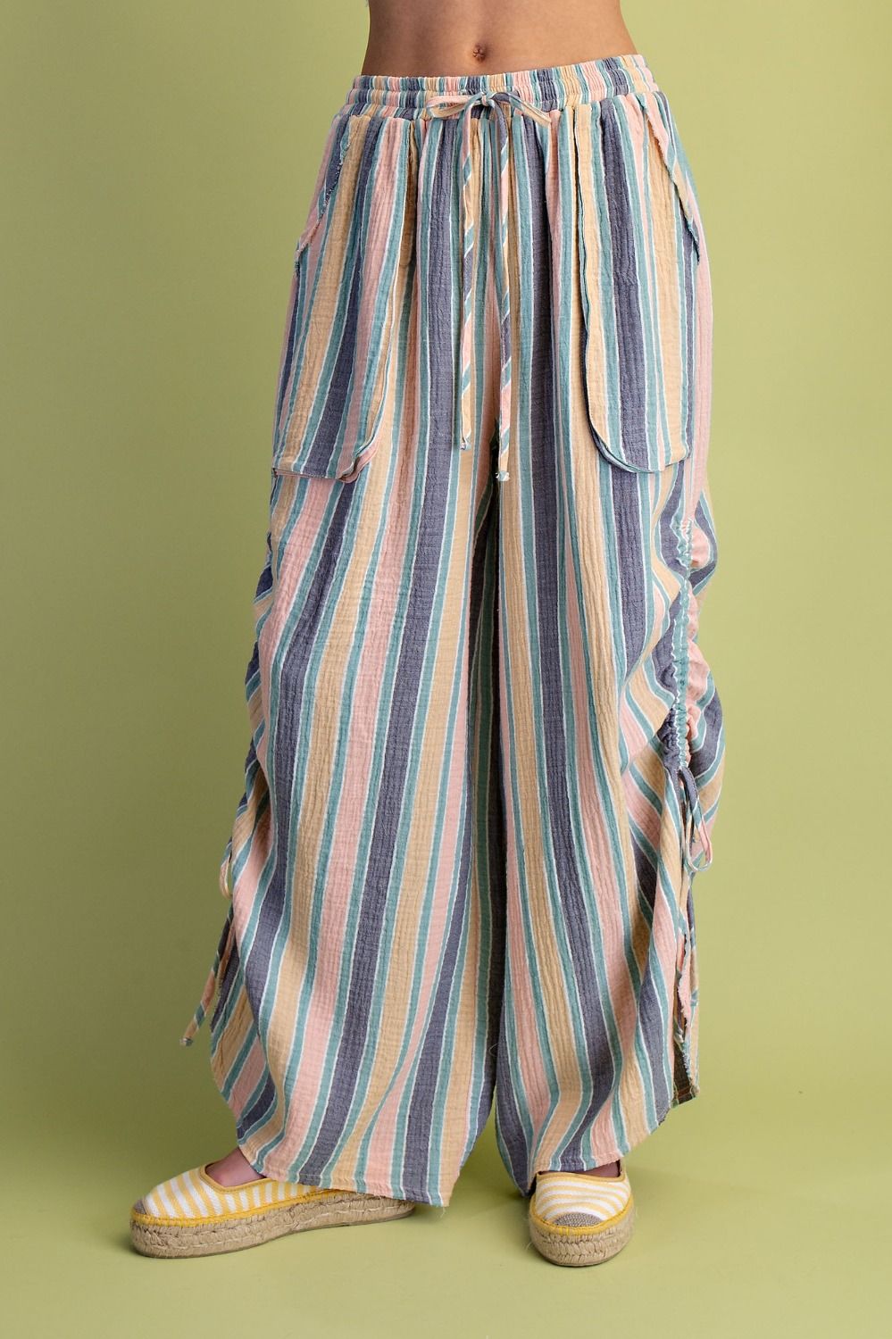 Striped wide-leg pants on a green background