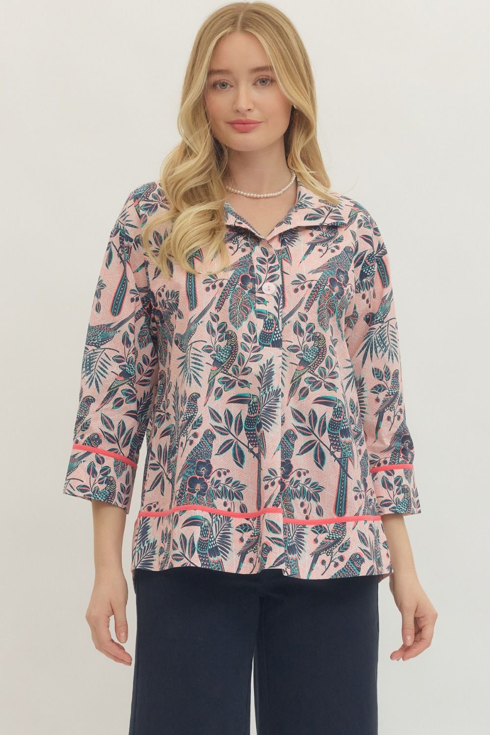 Woman wearing a floral patterned jacket on a plain background