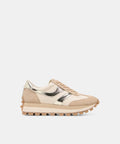 A low-top sneaker in beige and cream suede with metallic gold panels and a chunky lug sole, shown from the side on a light gray background.