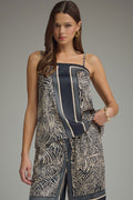 Woman wearing a patterned dress with a gray background