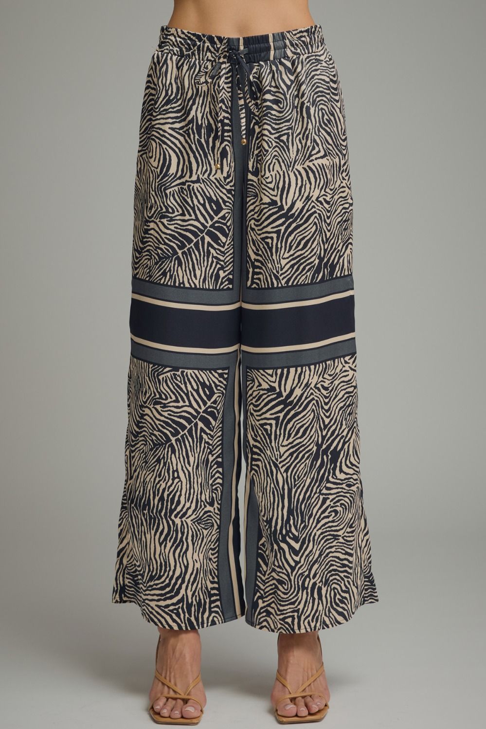 Long zebra print pants with a gray background