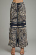 Long zebra print pants with a gray background