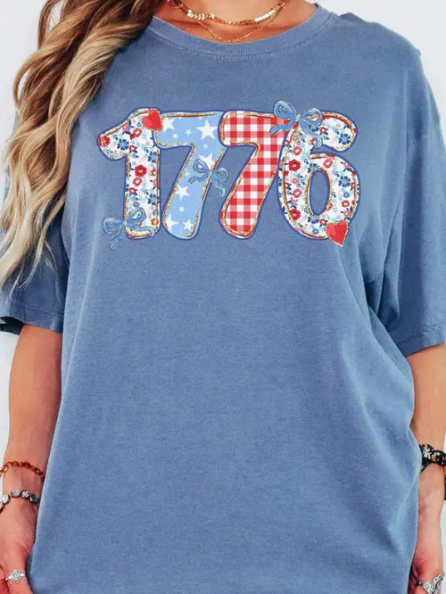 Blue t-shirt with '1776' design featuring stars and stripes on a white background